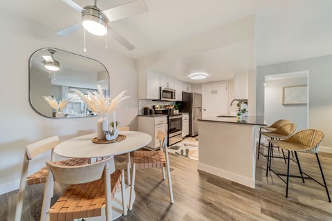 a dining area with a table and chairs and a kitchen in the background  at Citrine Hills, Ontario, CA, 91761